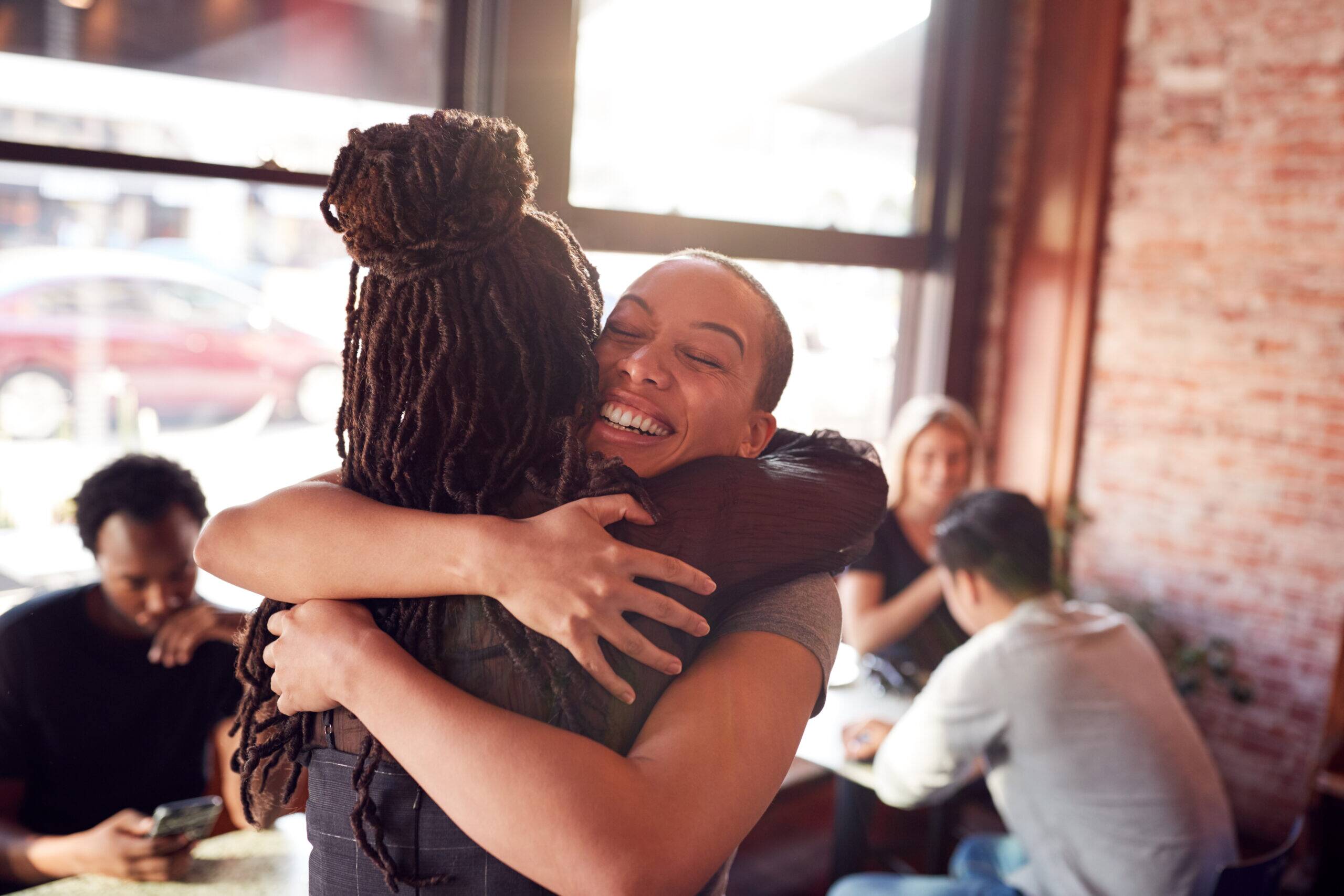 girl hugging and supporting a family member or friend maintain sobriety in early recovery