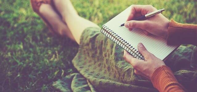 woman journaling in a gardenn