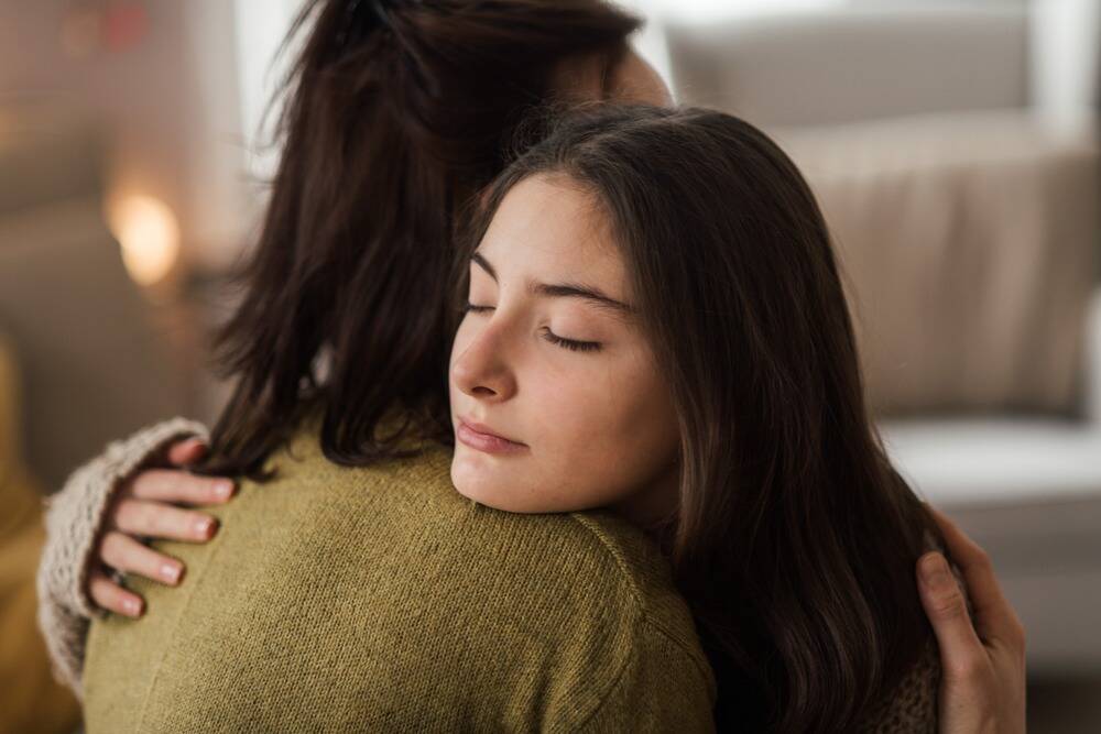 woman supporting a loved one in addiction recovery, woman intervening the early signs of relapse in loved one