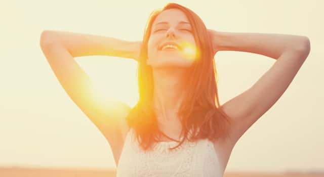 happy woman sitting in the sunlight