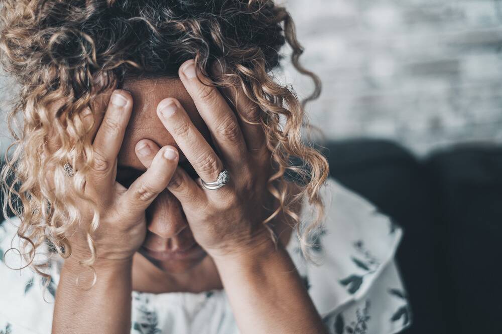 the signs and symptoms of anxiety, woman experiencing anxiety symptoms and stress, trying to find calm during anxiety attack