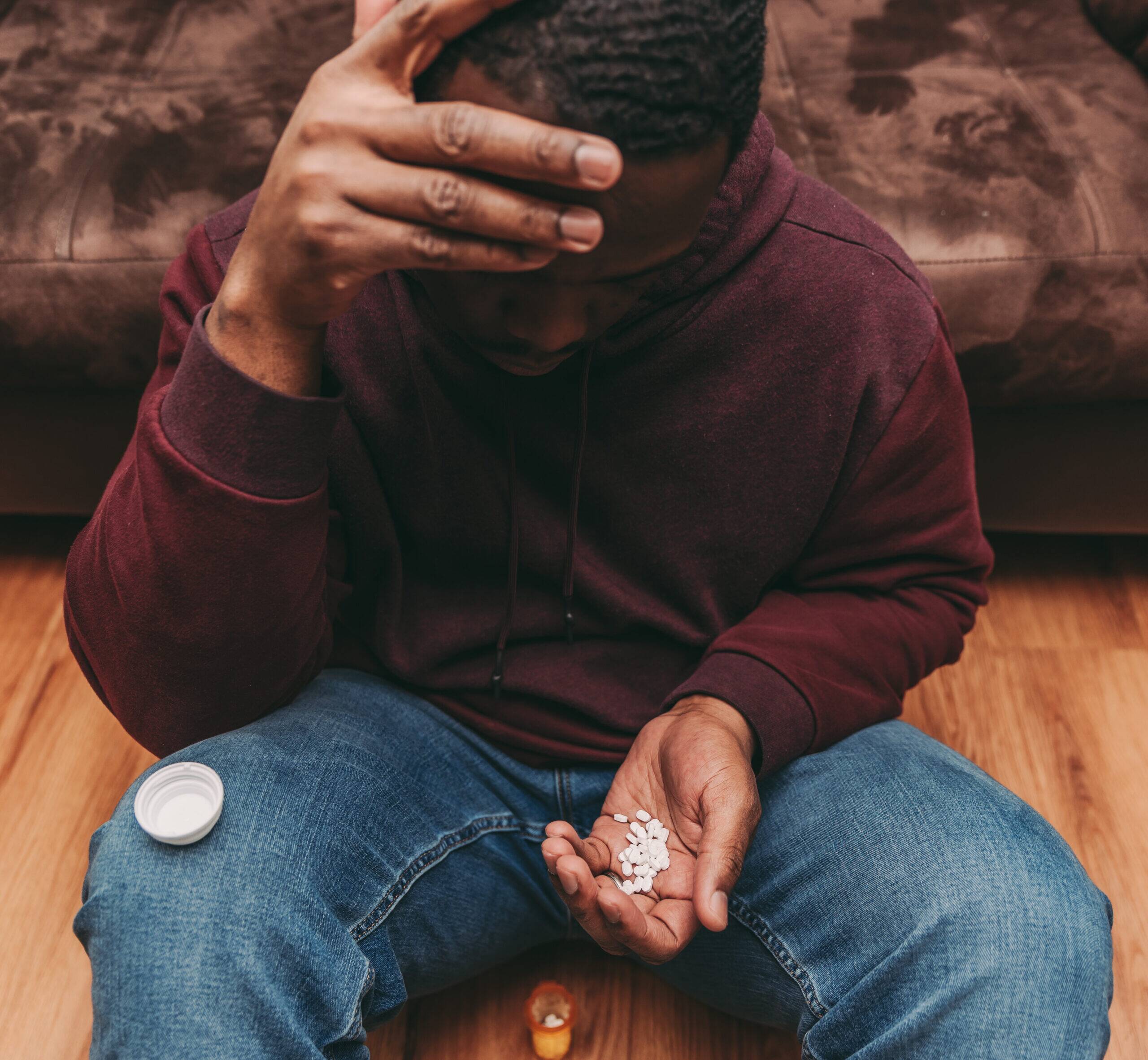 black or african american man struggling with addiction and drug overdose