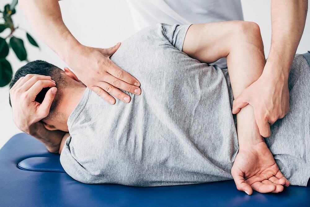 Chiropractor adjusting patient