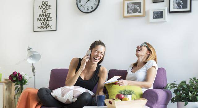 two girl roommates laughing 